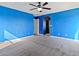 Carpeted bedroom with blue walls, a ceiling fan, and access to bathroom and closet for comfortable living at 1012 Water Cove St, Henderson, NV 89011