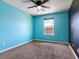 Bedroom featuring blue walls, a ceiling fan, and a contrasting black accent wall at 1012 Water Cove St, Henderson, NV 89011