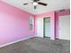 Bedroom featuring neutral carpet, a closet, and painted pink walls, creating a cozy atmosphere at 1012 Water Cove St, Henderson, NV 89011