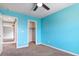 Bedroom with blue walls, white trim, ceiling fan, and closet at 1012 Water Cove St, Henderson, NV 89011