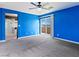 Vibrant bedroom with blue wall and a sliding glass door to the patio, and a bathroom doorway at 1012 Water Cove St, Henderson, NV 89011