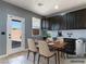 Chic dining area with dark cabinetry, modern chairs, and outdoor views at 1012 Water Cove St, Henderson, NV 89011