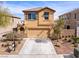 Inviting two-story home with desert landscaping, two-car garage and covered entryway, creating curb appeal at 1012 Water Cove St, Henderson, NV 89011