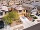 Aerial view of a charming tan two-story home with a well-manicured lawn and inviting curb appeal at 1012 Water Cove St, Henderson, NV 89011