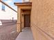 Warm home exterior featuring a sheltered front door with gravel landscaping at 1012 Water Cove St, Henderson, NV 89011