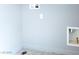 A bright laundry room with light gray painted walls and hookups for a washing machine and dryer at 1012 Water Cove St, Henderson, NV 89011