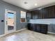 Versatile room with dark cabinets, built-in counter space, and access to the backyard at 1012 Water Cove St, Henderson, NV 89011