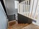 Carpeted staircase with white and black railings, providing a safe and stylish transition between floors at 1012 Water Cove St, Henderson, NV 89011