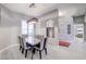 Modern dining room with gray chairs and a glass-top table at 10201 Los Padres Pl, Las Vegas, NV 89134