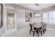 Elegant dining room with modern light fixture and seating for six at 10201 Los Padres Pl, Las Vegas, NV 89134