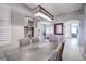 Spacious dining area with contemporary light fixture and six chairs at 10201 Los Padres Pl, Las Vegas, NV 89134