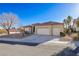 Single-story home with a three-car garage and mature landscaping at 10201 Los Padres Pl, Las Vegas, NV 89134