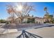 Single-story home with a three-car garage and nicely landscaped yard at 10201 Los Padres Pl, Las Vegas, NV 89134