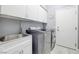 Bright laundry room with washer, dryer and utility sink at 10201 Los Padres Pl, Las Vegas, NV 89134