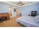 Main bedroom with a large bed, built-in desk, and access to the bathroom at 10718 Del Rudini St, Las Vegas, NV 89141