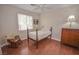 Cozy bedroom featuring hardwood floors and antique furniture at 10718 Del Rudini St, Las Vegas, NV 89141