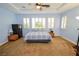 Serene bedroom with light blue walls, a comfortable bed, and plenty of natural light at 10718 Del Rudini St, Las Vegas, NV 89141