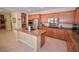 Island kitchen with stainless steel appliances and wood cabinets at 10718 Del Rudini St, Las Vegas, NV 89141