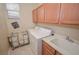 Functional laundry room with built-in cabinets and a utility sink at 10718 Del Rudini St, Las Vegas, NV 89141