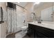 Bathroom featuring a shower-tub combo and a vanity with dark wood cabinetry at 11290 Hazel Rock St, Las Vegas, NV 89179