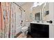 Bathroom featuring a shower-tub combo and a vanity with dark wood cabinetry at 11290 Hazel Rock St, Las Vegas, NV 89179