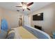 Cozy bedroom featuring soft carpet, ceiling fan, and a mounted flat-screen TV at 11290 Hazel Rock St, Las Vegas, NV 89179