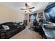 Bedroom featuring a cozy sofa, ceiling fan, and a dedicated workspace at 11290 Hazel Rock St, Las Vegas, NV 89179