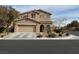 Two story home with a two car garage, mature landscaping, and an arched front entryway at 11290 Hazel Rock St, Las Vegas, NV 89179