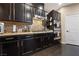 Modern kitchen featuring granite countertops, stainless steel appliances, and dark wood cabinetry at 11290 Hazel Rock St, Las Vegas, NV 89179