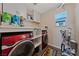 Functional laundry room with modern red washer and dryer set and ample storage at 11290 Hazel Rock St, Las Vegas, NV 89179