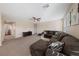 Spacious carpeted living room with a large sectional sofa and entertainment center at 11290 Hazel Rock St, Las Vegas, NV 89179