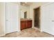 Bathroom featuring a double mirror, wooden cabinets, and a glass door shower with marbled tile surround at 12 Oro Valley Dr, Henderson, NV 89052