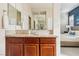 Bathroom features a double vanity, large mirror, and view into the main bedroom at 12 Oro Valley Dr, Henderson, NV 89052