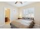 Inviting bedroom featuring plantation shutters, ceiling fan, and en-suite bath at 12 Oro Valley Dr, Henderson, NV 89052