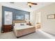 Primary bedroom with shutters, blue accent wall, and ensuite bathroom with soaking tub at 12 Oro Valley Dr, Henderson, NV 89052