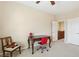 Bright bedroom featuring neutral walls, ceiling fan, a cozy chair, and a desk with a red chair at 12 Oro Valley Dr, Henderson, NV 89052