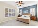 Comfortable bedroom with neutral carpet, plantation shutters, ceiling fan, and a calming blue accent wall at 12 Oro Valley Dr, Henderson, NV 89052