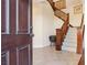 Interior entryway with tiled floor and wooden staircase at 12 Oro Valley Dr, Henderson, NV 89052