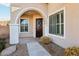 Elegant entryway with arched doorway, decorative wreath, and window shutters at 12 Oro Valley Dr, Henderson, NV 89052