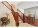 Open stairway with wood railings, connecting to a dining area with a round table and chairs on hardwood floors at 12 Oro Valley Dr, Henderson, NV 89052