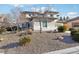 Two-story house with beige exterior, landscaped yard, and a two-car garage at 12 Oro Valley Dr, Henderson, NV 89052