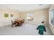 Game room with a round table, chairs, putting green, and large windows at 12 Oro Valley Dr, Henderson, NV 89052