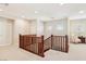 Hallway with wooden railings, neutral walls, and a comfy chair at 12 Oro Valley Dr, Henderson, NV 89052