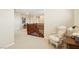 Bright hallway with wooden railing and a chair; lovely neutral paint and carpet throughout the upper level at 12 Oro Valley Dr, Henderson, NV 89052