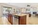 Kitchen island with stainless steel dishwasher is open to the dining area and living room with fireplace at 12 Oro Valley Dr, Henderson, NV 89052