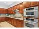 Kitchen boasts stainless steel appliances and wood cabinetry at 12 Oro Valley Dr, Henderson, NV 89052