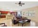 Well-lit open living room with hardwood floors and a large sofa, seamlessly connecting to a well-equipped kitchen at 12 Oro Valley Dr, Henderson, NV 89052