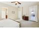 Bright main bedroom with neutral colors, ceiling fan, carpet, and a door to the outside at 12 Oro Valley Dr, Henderson, NV 89052