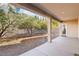 Covered patio overlooking the backyard and trees at 12 Oro Valley Dr, Henderson, NV 89052