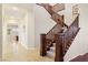 Elegant staircase with wooden banister and carpeted steps leading to the upper level of the home at 12 Oro Valley Dr, Henderson, NV 89052